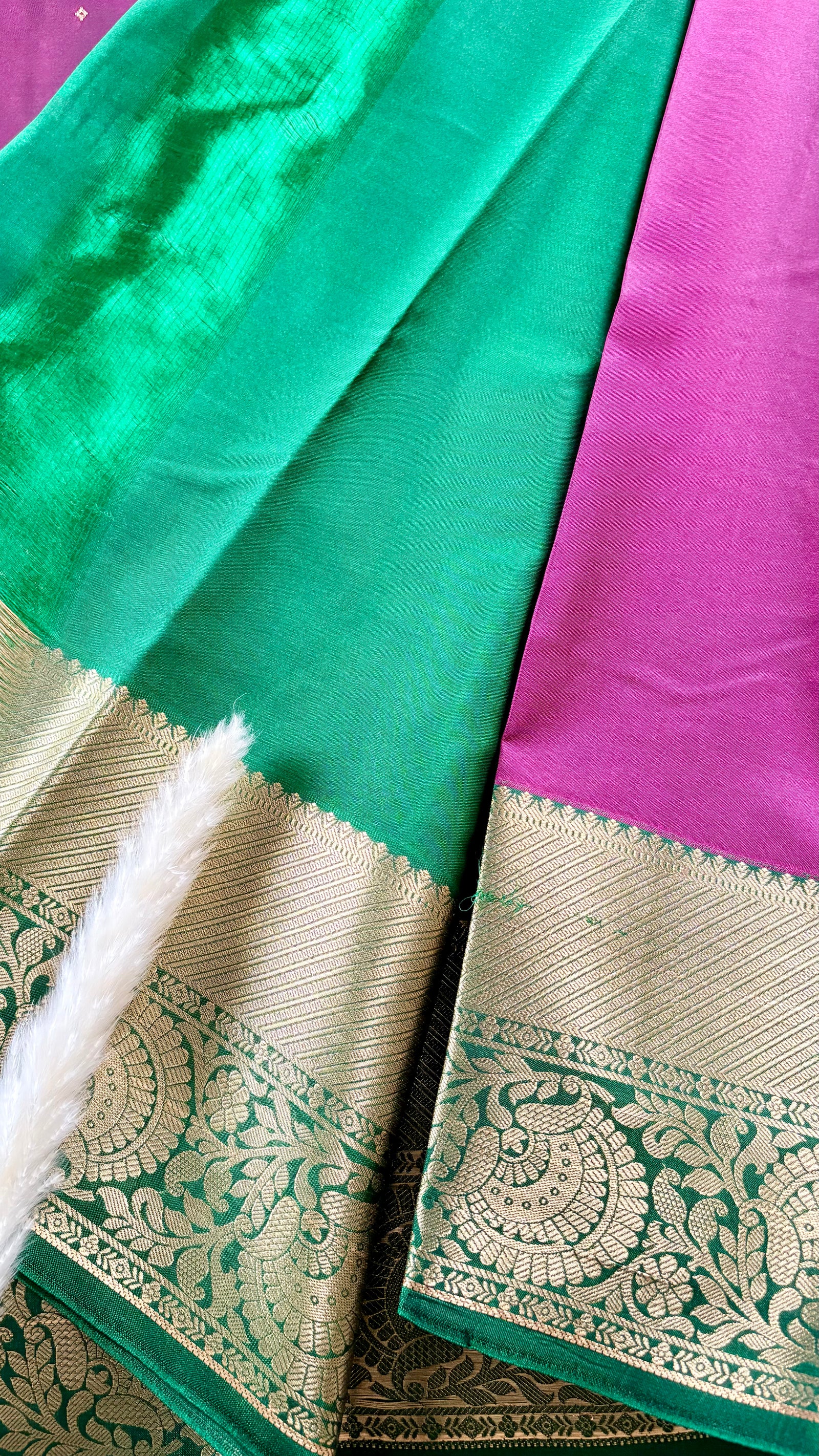 Kanchipuram silk saree featuring a magenta-pink body paired with an elaborate green and gold zari border  (Saree Code - S100)