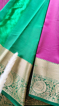 Kanchipuram silk saree featuring a magenta-pink body paired with an elaborate green and gold zari border  (Saree Code - S100)