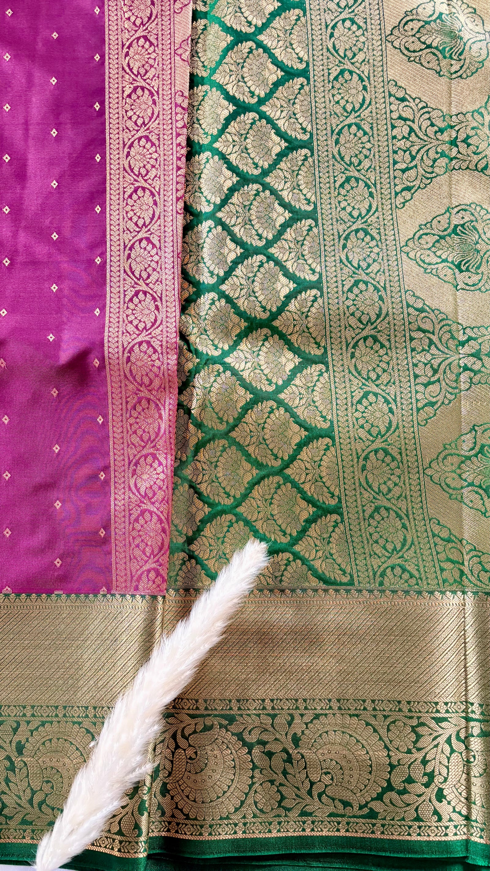Kanchipuram silk saree featuring a magenta-pink body paired with an elaborate green and gold zari border  (Saree Code - S100)