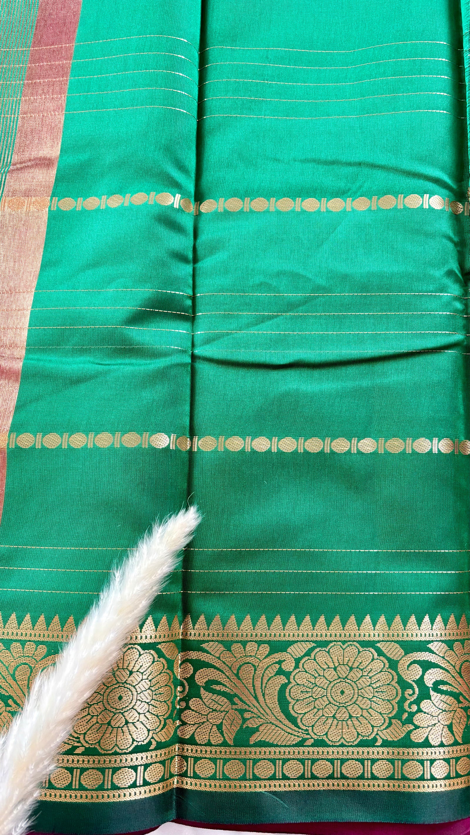 Deep Magenta soft silk saree featuring a traditional golden zari woven floral border and horizontal line accents  (Saree Code - S104)