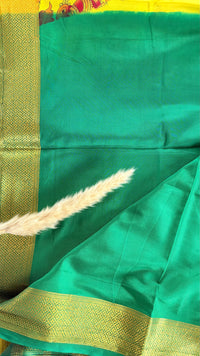 Beutiful yellow and green semi mysore crepe silk saree features vibrant floral and bird kalamkari print paired with a rich gold zari border (Saree Code - S71)