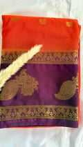 Featuribg an Orange body and a Wine-Coloured Border, Intircately woven with traditional goldern zari motifs (Saree Code - S72)