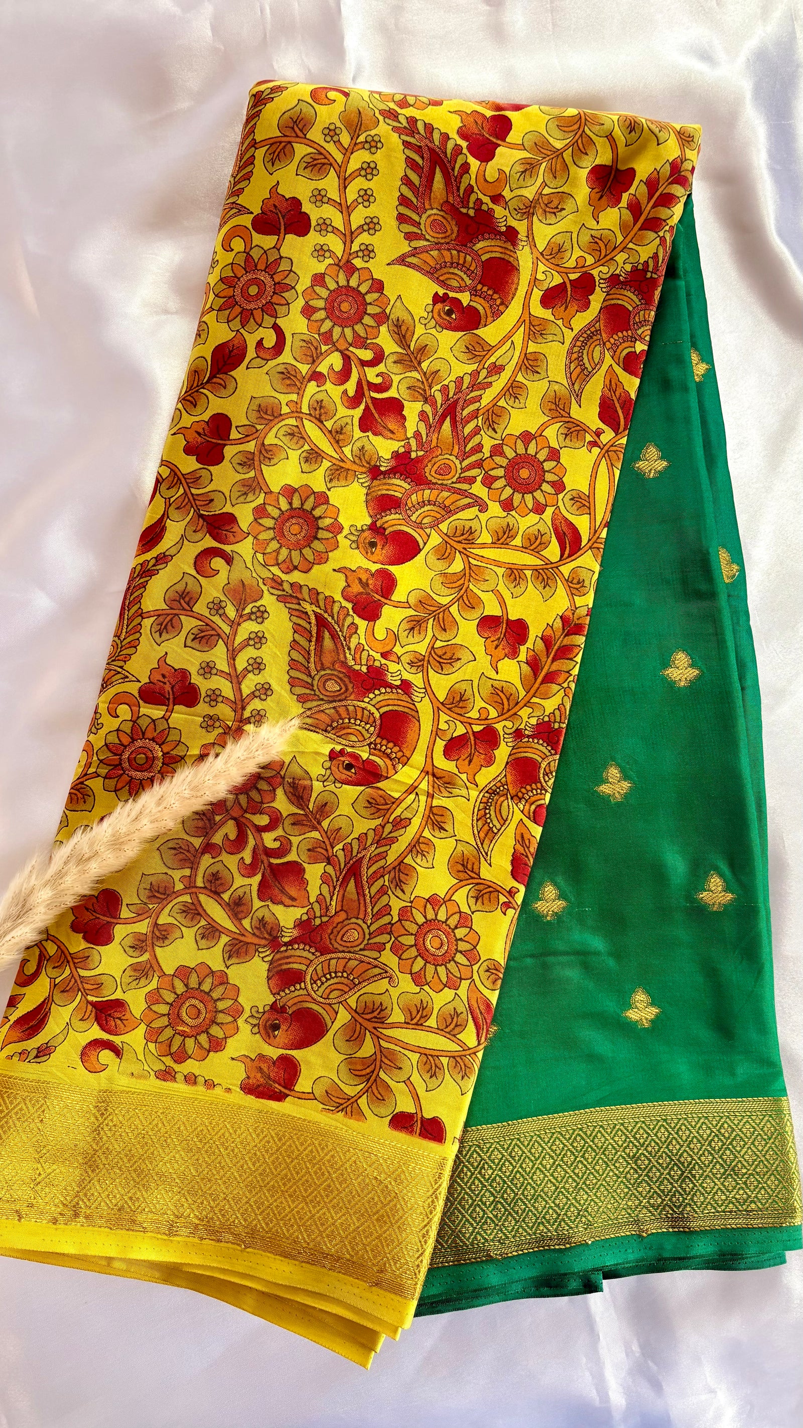 Beutiful yellow and green semi mysore crepe silk saree features vibrant floral and bird kalamkari print paired with a rich gold zari border (Saree Code - S71)