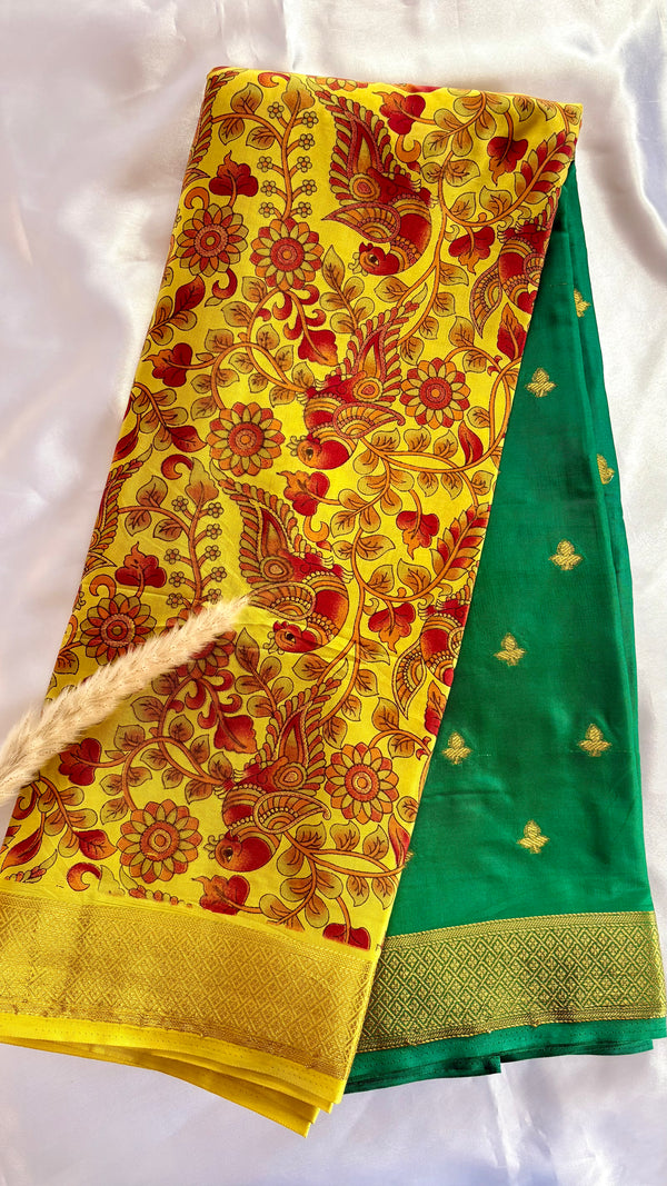 Beutiful yellow and green semi mysore crepe silk saree features vibrant floral and bird kalamkari print paired with a rich gold zari border (Saree Code - S71)