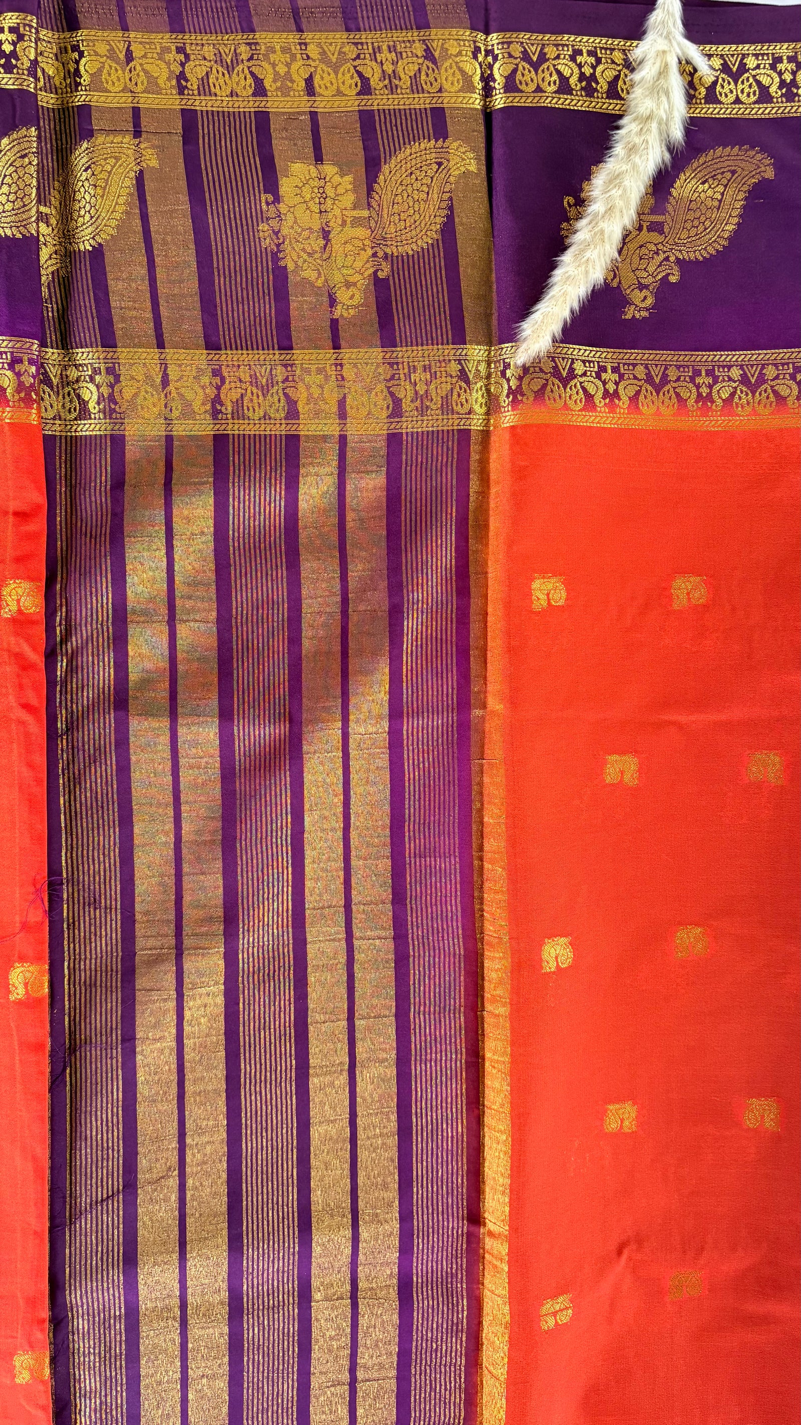 Featuribg an Orange body and a Wine-Coloured Border, Intircately woven with traditional goldern zari motifs (Saree Code - S72)