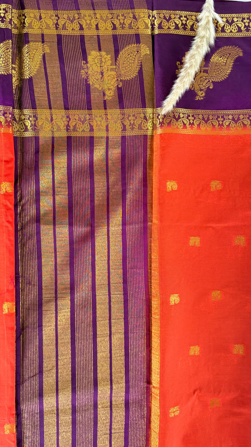 Featuribg an Orange body and a Wine-Coloured Border, Intircately woven with traditional goldern zari motifs (Saree Code - S72)