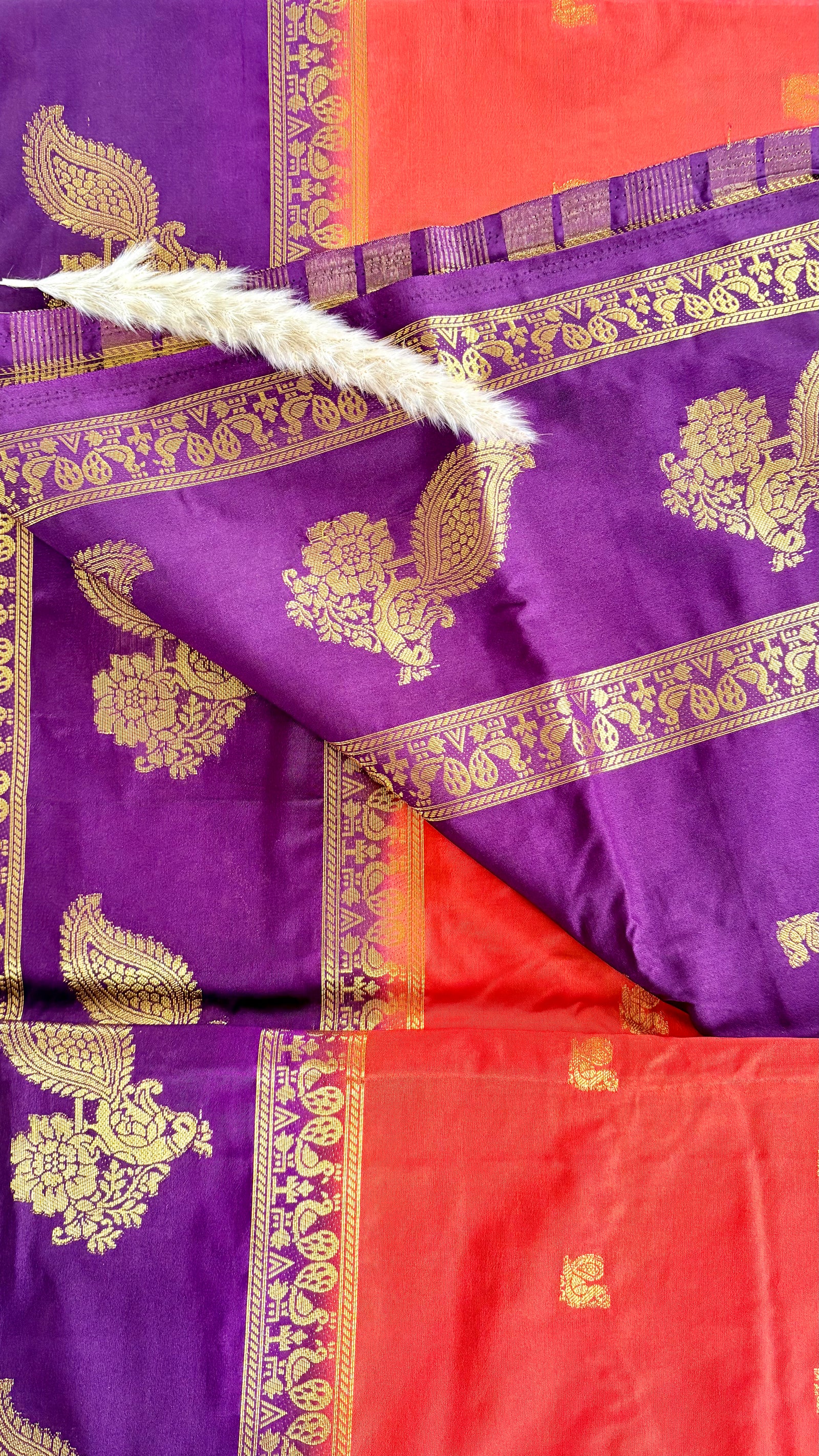 Featuribg an Orange body and a Wine-Coloured Border, Intircately woven with traditional goldern zari motifs (Saree Code - S72)