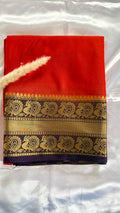 Vibrant Orange silk saree featuring a traditional woven golden zari peacock and floral motif border (Saree Code - S74)