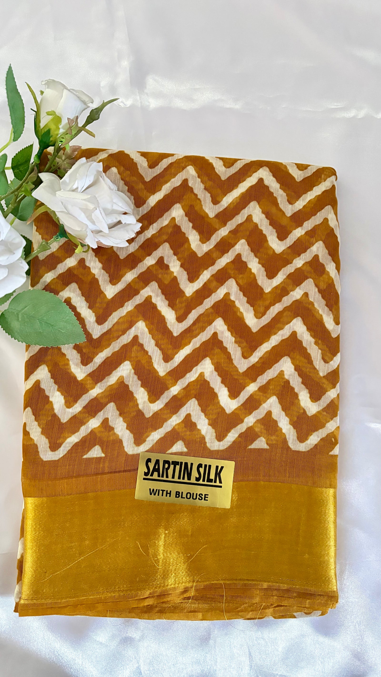 White Geometric zig-zag chevron print pattern warm mustard-brown hue, complemented by a traditional, glossy golden zari border  (Saree Code - S77)