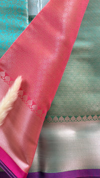 Kanchipuran Tissue silk saree featuring an intricate floral sea green body paired with a contract Lavender Zari Border ( (Saree Code - S92)