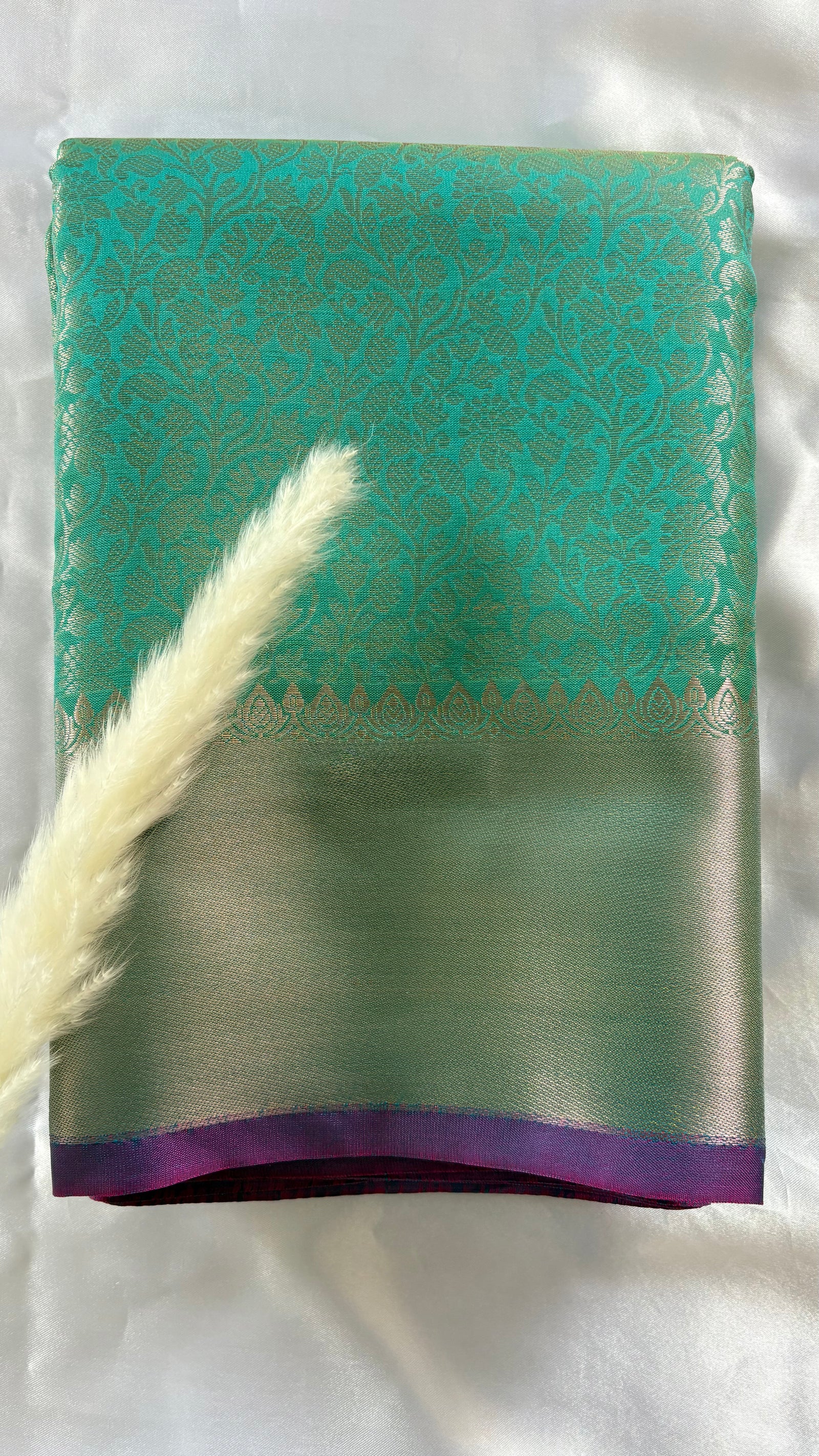 Kanchipuran Tissue silk saree featuring an intricate floral sea green body paired with a contract Lavender Zari Border ( (Saree Code - S92)