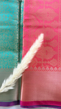 Kanchipuran Tissue silk saree featuring an intricate floral sea green body paired with a contract Lavender Zari Border ( (Saree Code - S92)