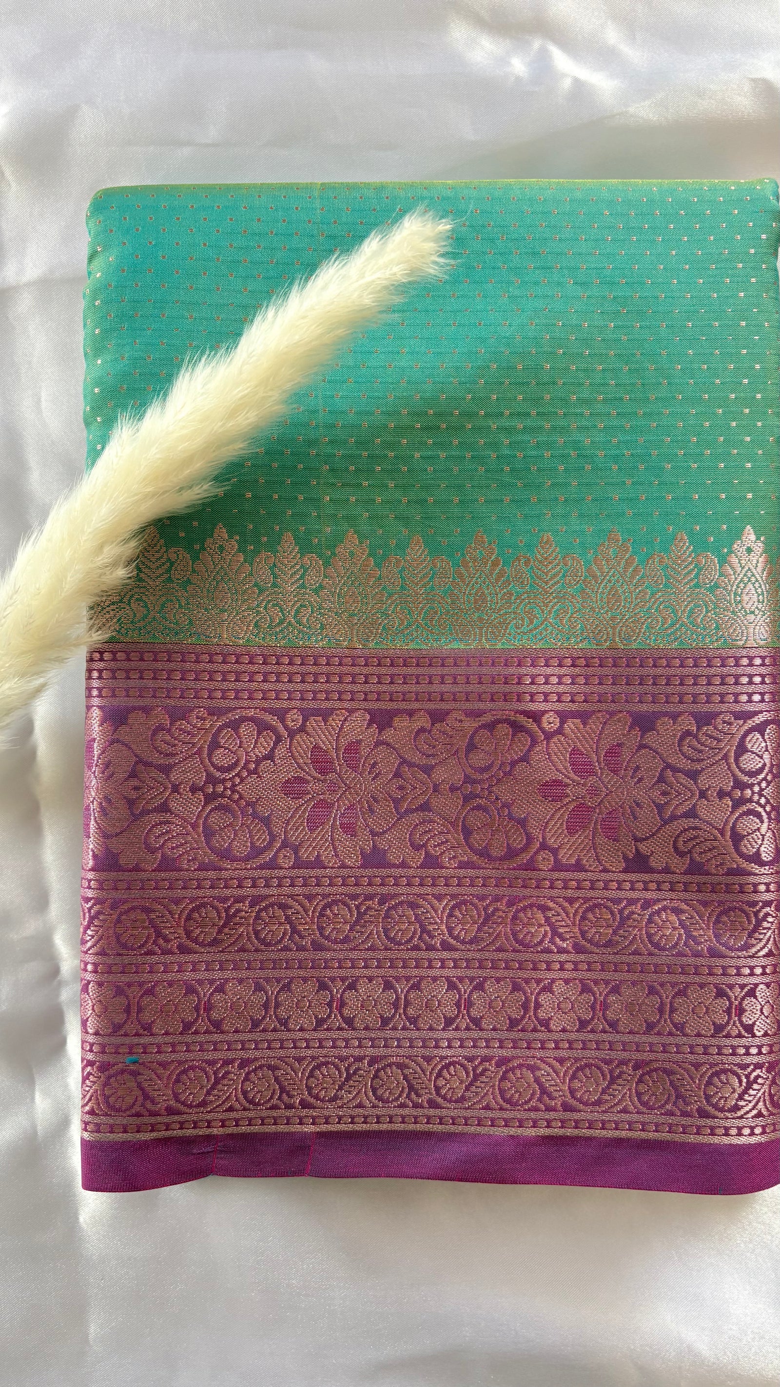 Stunning steal green kanchipuram silk saree featuring an elegant contract pink zari woven border and a matching pallu  (Saree Code - S94)