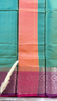 Stunning steal green kanchipuram silk saree featuring an elegant contract pink zari woven border and a matching pallu  (Saree Code - S94)