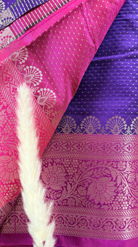 Vibrant purple body decorated with delicate allover woven buttas and a contrasting pastel pink border intricately styled with tradition floral Zari motifs  (Saree Code - S95)