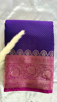 Vibrant purple body decorated with delicate allover woven buttas and a contrasting pastel pink border intricately styled with tradition floral Zari motifs  (Saree Code - S95)
