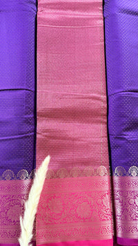 Vibrant purple body decorated with delicate allover woven buttas and a contrasting pastel pink border intricately styled with tradition floral Zari motifs  (Saree Code - S95)