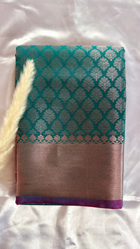 Kanchivarama wide metallic woven gold border and a contrasting purple selvedg Teal Greensilk saree, featuring intricate all-over floral leaf zari motifs and a contract metallic tissue border  (Saree Code - S96)